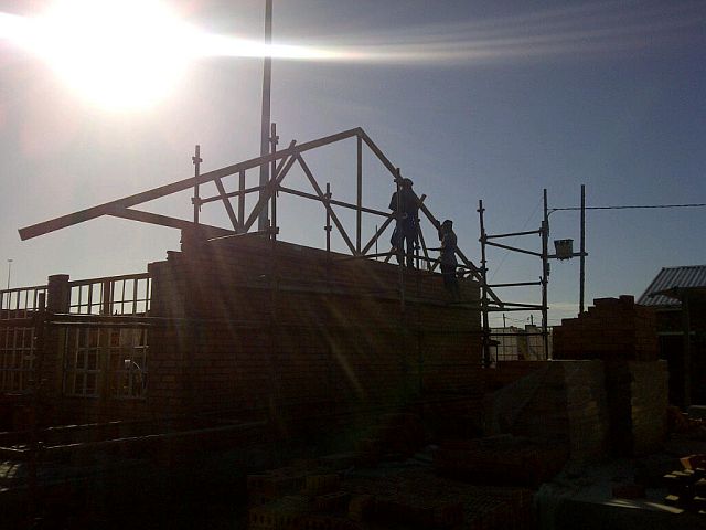 At daybreak, the 1st Truss is lifted into position on classroom block1